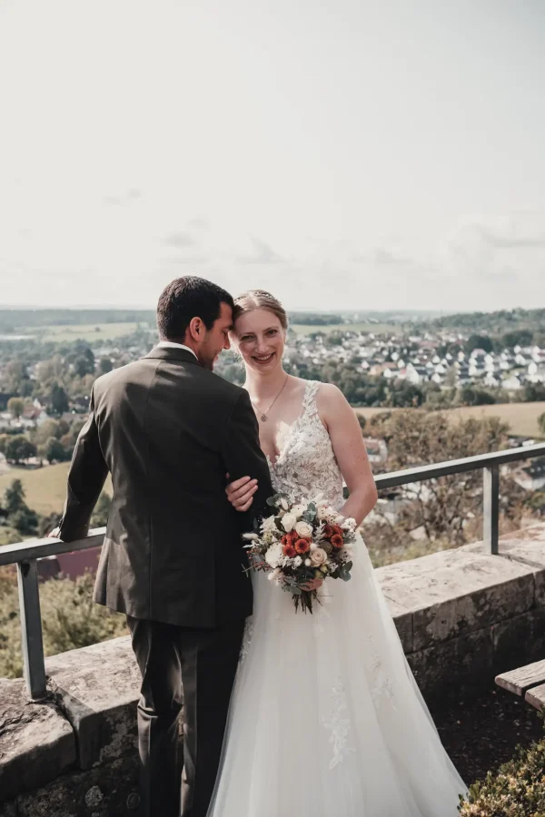 Braut eingehakt beim Bräutigam, Zuneigung und Lächeln