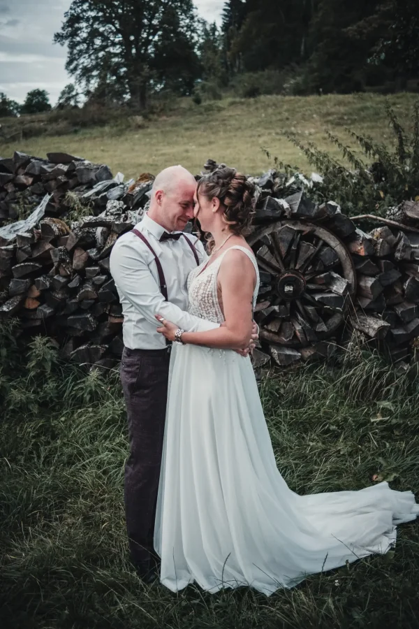 Silhouettenaufnahme des Brautpaars vor der malerischen Abendkulisse des Hofguts.